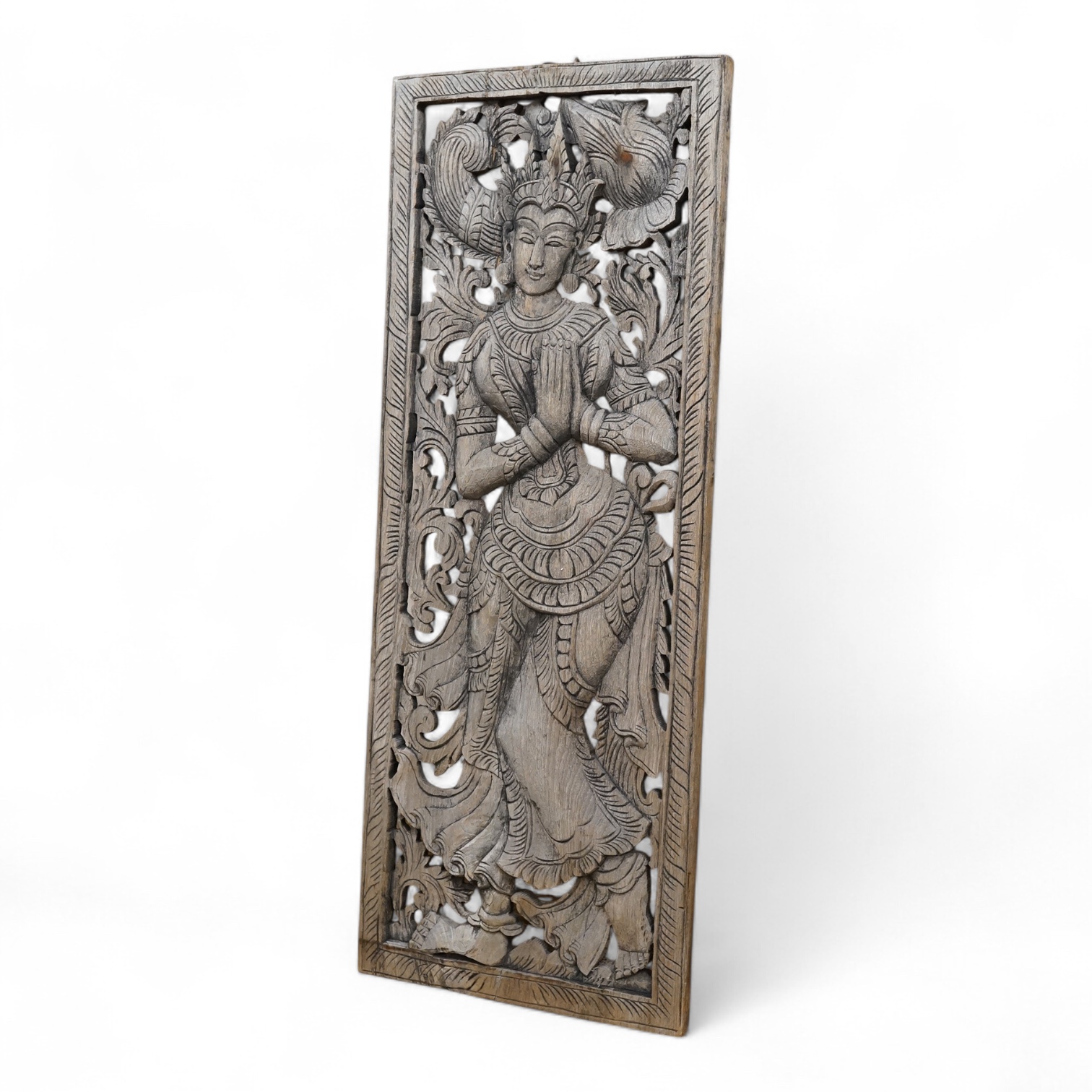 An Asian or Thai carved panel of a deity, 90cm high